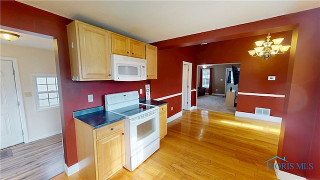 420 Ames St, Clyde, OH 43410 - kitchen featuring white appliances, light wood-type flooring, light brown cabinetry, and dark countertops