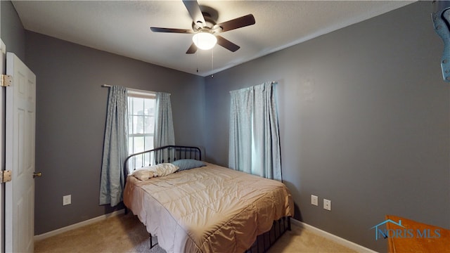 420 Ames St, Clyde, OH 43410 - bedroom with light colored carpet and a ceiling fan