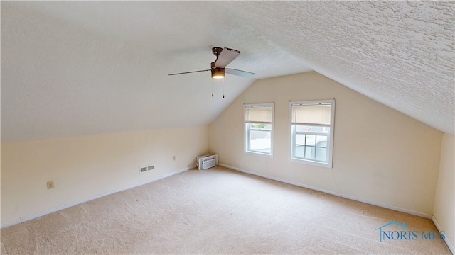 420 Ames St, Clyde, OH 43410 - additional living space with carpet, a textured ceiling, lofted ceiling, a wall mounted air conditioner, and a ceiling fan