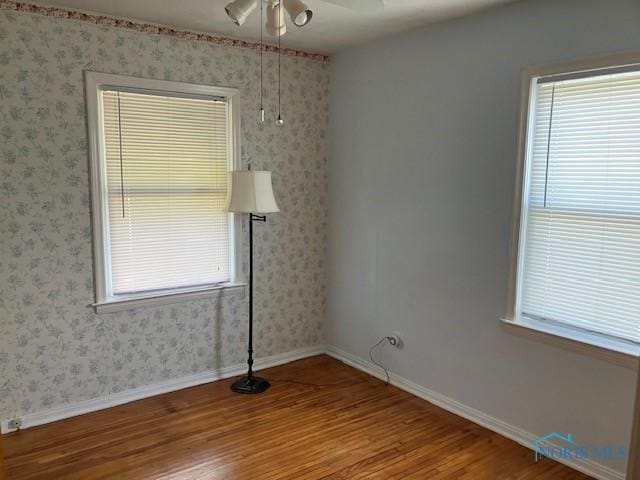 4614 290th St, Toledo, OH 43611 - empty room with wood finished floors, a ceiling fan, and wallpapered walls
