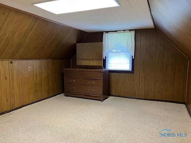 4614 290th St, Toledo, OH 43611 - bonus room with wooden walls, vaulted ceiling, and light carpet