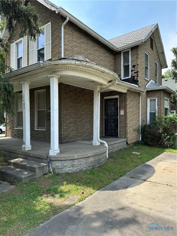 2401 N Summit St, Toledo, OH 43611 - view of front facade featuring covered porch and brick siding