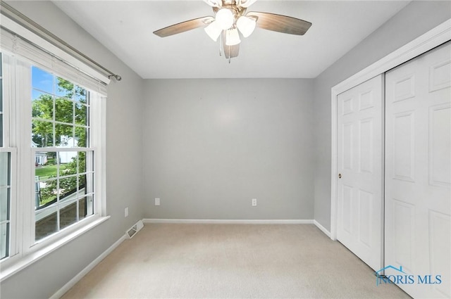 8076 Bridgehampton Dr, Waterville, OH 43566 - unfurnished bedroom featuring light carpet, a closet, and ceiling fan