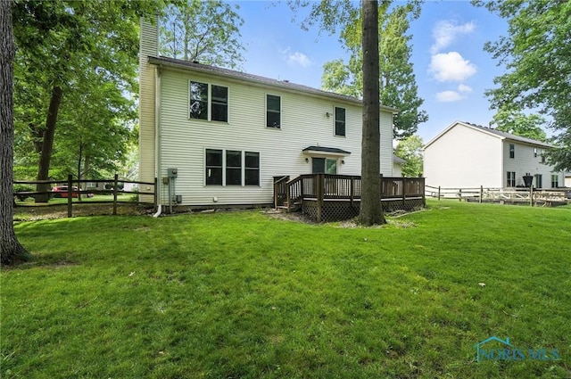 8076 Bridgehampton Dr, Waterville, OH 43566 - back of property featuring a chimney, a deck, and a fenced backyard