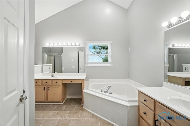 8076 Bridgehampton Dr, Waterville, OH 43566 - bathroom featuring a shower stall, two vanities, a bath, and lofted ceiling
