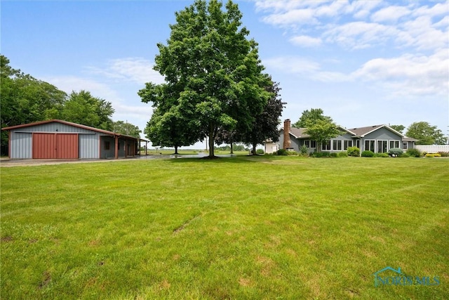 15180 Dirlam Rd, Bowling Green, OH 43402 - view of green lawn featuring an outbuilding, a detached garage, and an outdoor structure