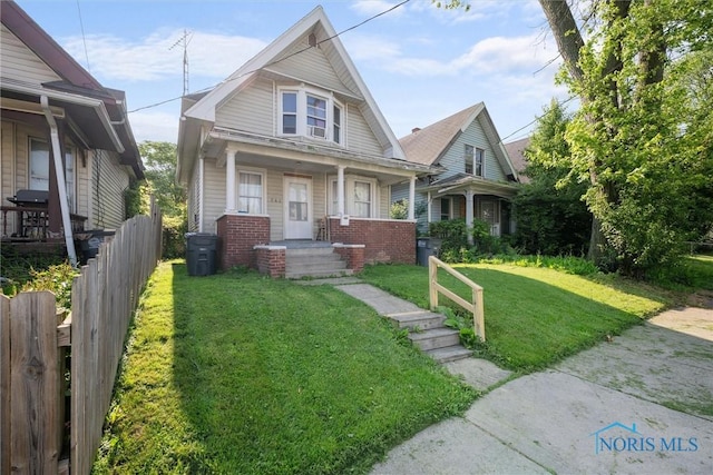 743 Clark St, Toledo, OH 43605 - bungalow with brick siding and a porch