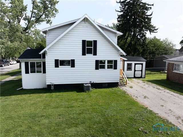 1130 Alger St, Fremont, OH 43420 - rear view of property featuring a storage shed, a yard, and driveway