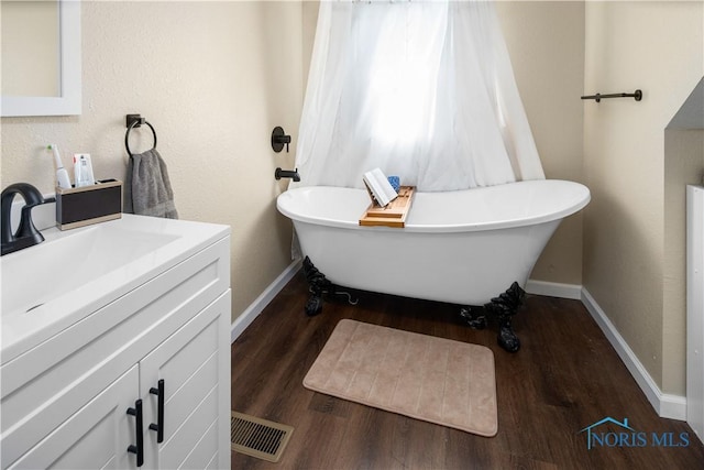 1130 Alger St, Fremont, OH 43420 - bathroom with vanity, wood finished floors, and a soaking tub