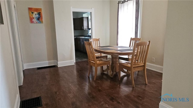 4024 Commonwealth Ave, Toledo, OH 43612 - dining room featuring dark wood-type flooring and baseboards