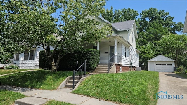 4024 Commonwealth Ave, Toledo, OH 43612 - view of property hidden behind natural elements featuring an outdoor structure, a detached garage, driveway, and a front yard