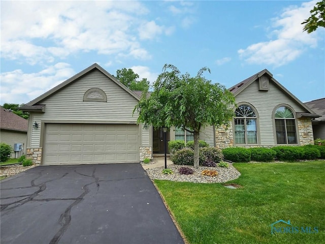 3901 Hampstead Dr Unit 3901, Sylvania, OH 43560 - ranch-style house featuring stone siding, asphalt driveway, a front lawn, and a garage