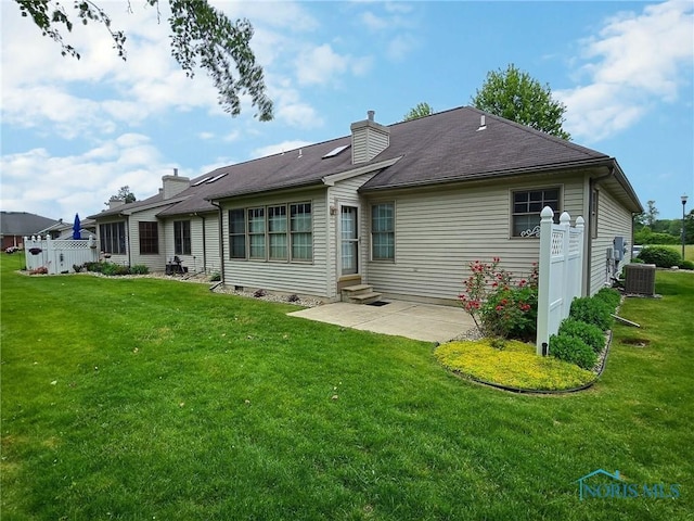 3901 Hampstead Dr Unit 3901, Sylvania, OH 43560 - back of property with entry steps, a patio, a yard, and a chimney