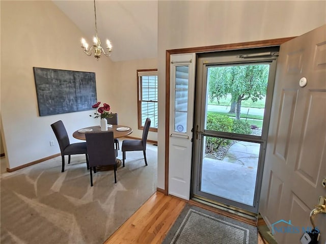 3901 Hampstead Dr Unit 3901, Sylvania, OH 43560 - dining room featuring a chandelier, light wood-style floors, and high vaulted ceiling