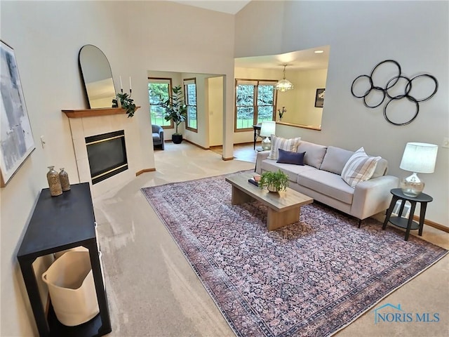 3901 Hampstead Dr Unit 3901, Sylvania, OH 43560 - carpeted living room featuring a tile fireplace and a high ceiling