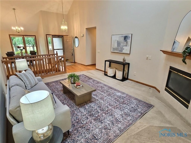 3901 Hampstead Dr Unit 3901, Sylvania, OH 43560 - living area with high vaulted ceiling, a fireplace, a chandelier, and carpet flooring