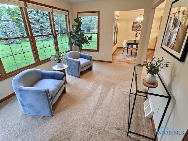 3901 Hampstead Dr Unit 3901, Sylvania, OH 43560 - living room featuring a chandelier and light carpet