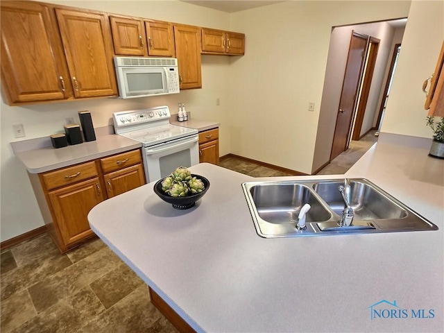3901 Hampstead Dr Unit 3901, Sylvania, OH 43560 - kitchen featuring white appliances, brown cabinetry, and light countertops