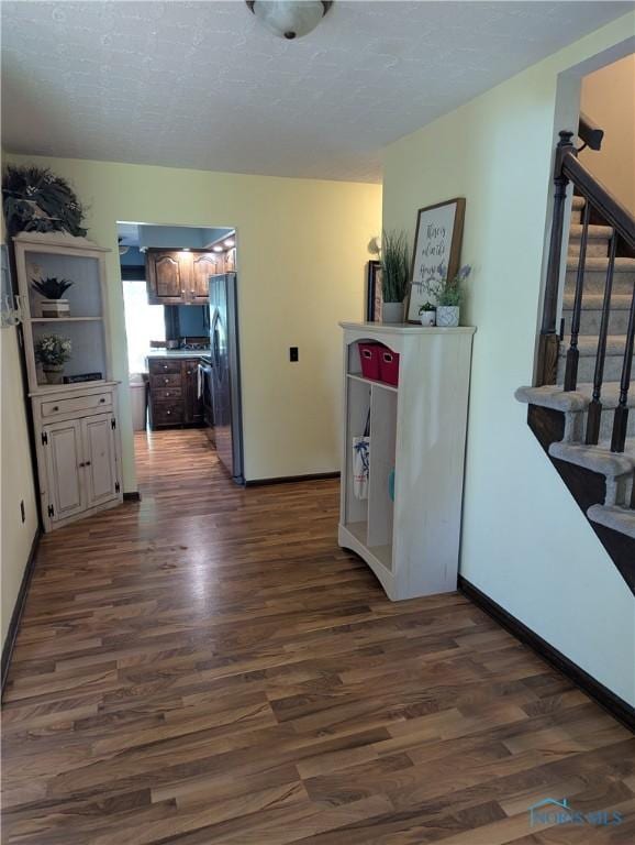 16020 County Road D, Wauseon, OH 43567 - kitchen with freestanding refrigerator, dark wood-style floors, and a textured ceiling