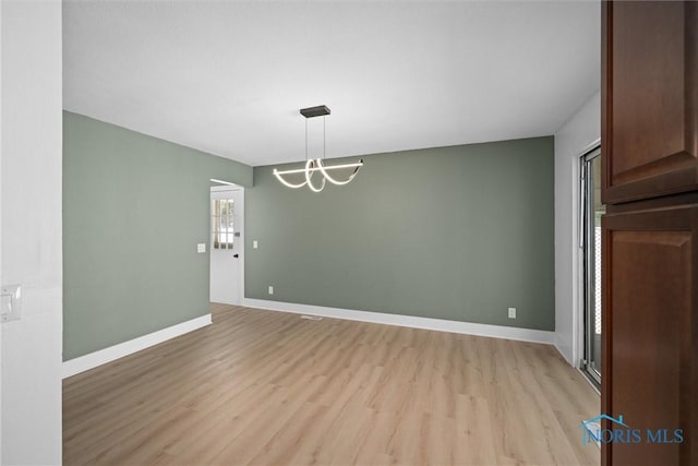 2521 Shallowford Dr, Toledo, OH 43611 - unfurnished dining area with light wood finished floors and a chandelier