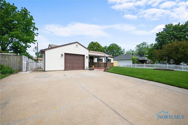 2521 Shallowford Dr, Toledo, OH 43611 - view of home's exterior with concrete driveway, a garage, and a gate