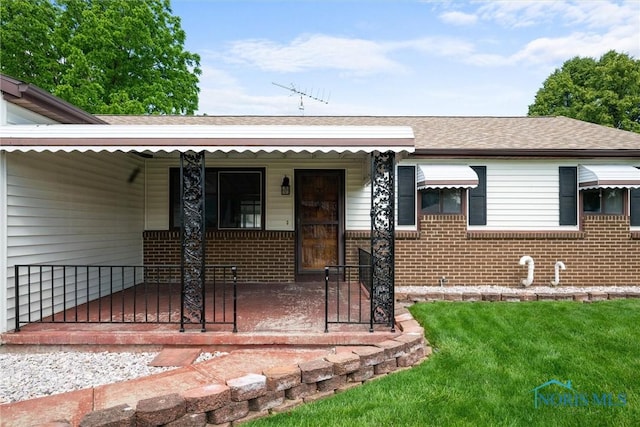 2521 Shallowford Dr, Toledo, OH 43611 - view of front of house with covered porch, brick siding, and roof with shingles
