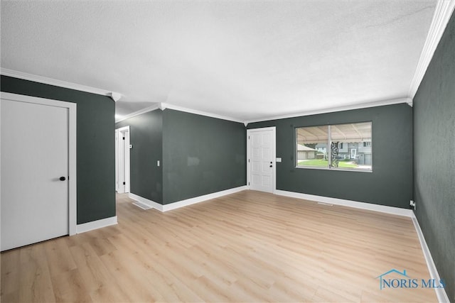 2521 Shallowford Dr, Toledo, OH 43611 - unfurnished room with crown molding, light wood-type flooring, and a textured ceiling
