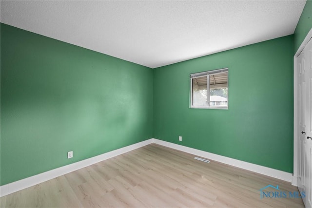 2521 Shallowford Dr, Toledo, OH 43611 - spare room with wood finished floors and a textured ceiling