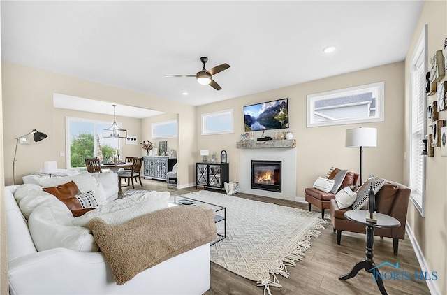 5352 Brint Crossing Blvd, Sylvania, OH 43560 - living room featuring dark wood-style floors, a ceiling fan, a glass covered fireplace, and recessed lighting
