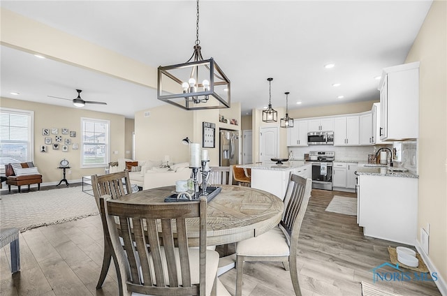 5352 Brint Crossing Blvd, Sylvania, OH 43560 - dining room with wood finished floors, a ceiling fan, a chandelier, and recessed lighting