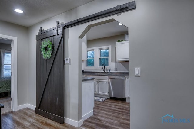 525 Western Ave, Findlay, OH 45840 - hall featuring a barn door, dark wood-style flooring, recessed lighting, and arched walkways