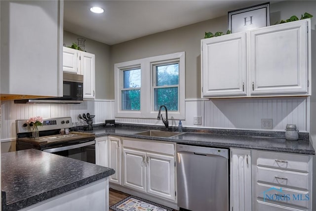 525 Western Ave, Findlay, OH 45840 - kitchen featuring appliances with stainless steel finishes, dark countertops, white cabinetry, recessed lighting, and wood finished floors