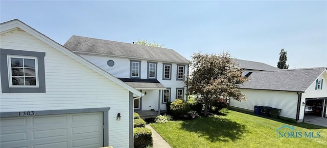 1303 Finch Dr, Bowling Green, OH 43402 - view of front of property featuring a front lawn and a garage
