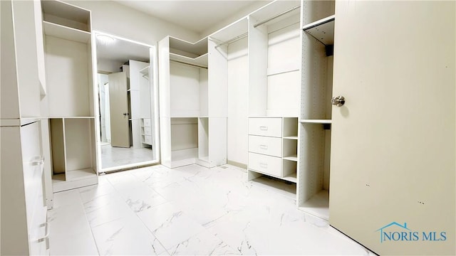 1303 Finch Dr, Bowling Green, OH 43402 - walk in closet featuring light marble finish floors