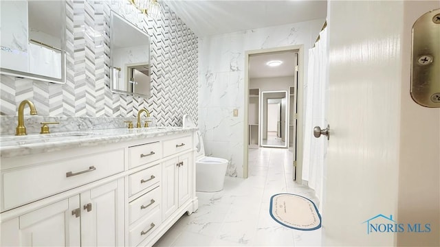 1303 Finch Dr, Bowling Green, OH 43402 - bathroom featuring marble finish floors, tile walls, and double vanity