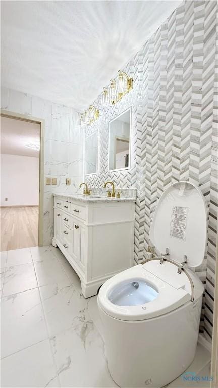 1303 Finch Dr, Bowling Green, OH 43402 - bathroom featuring vanity, tile walls, and marble finish flooring