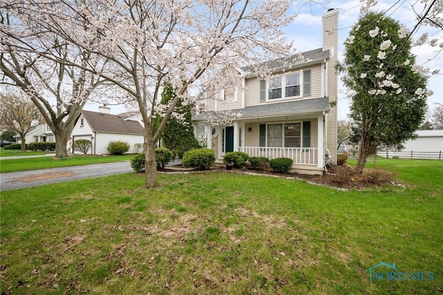 1528 Indian Creek Dr, Perrysburg, OH 43551 - traditional home with a porch, a chimney, a front lawn, and driveway