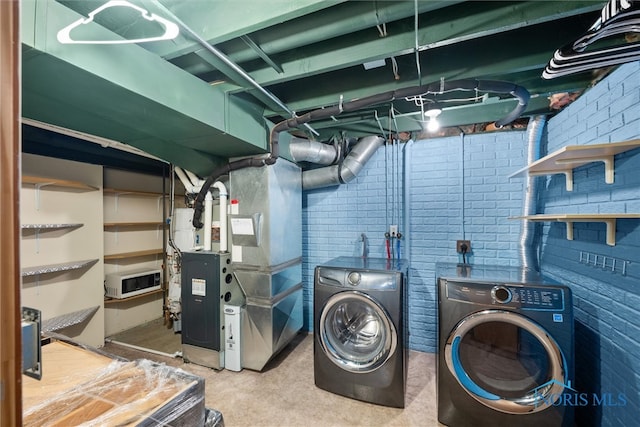 1528 Indian Creek Dr, Perrysburg, OH 43551 - laundry area featuring independent washer and dryer, heating unit, and brick wall