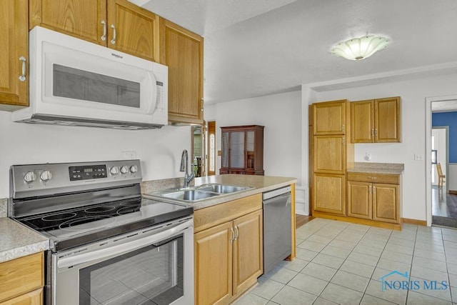 3133 126th St, Toledo, OH 43611 - kitchen featuring stainless steel appliances, light countertops, and light tile patterned flooring