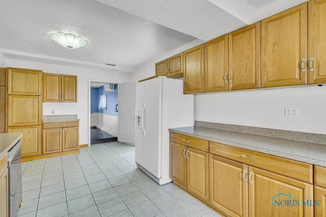 3133 126th St, Toledo, OH 43611 - kitchen with white refrigerator with ice dispenser, light tile patterned floors, stainless steel dishwasher, and brown cabinetry