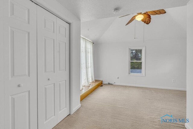 3133 126th St, Toledo, OH 43611 - unfurnished bedroom featuring multiple windows, carpet floors, a closet, lofted ceiling, and a ceiling fan