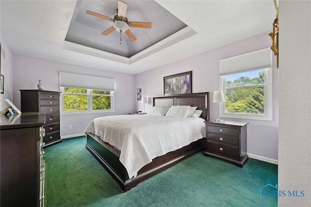 7713 Rome Ct, Holland, OH 43528 - carpeted bedroom with a raised ceiling and a ceiling fan