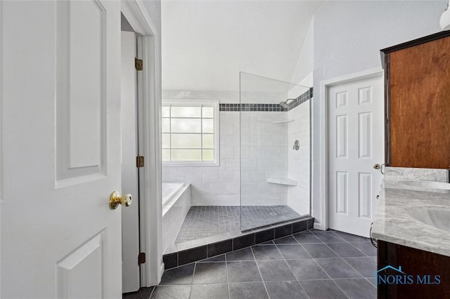 7713 Rome Ct, Holland, OH 43528 - full bathroom featuring tile patterned flooring, a tile shower, a garden tub, and double vanity