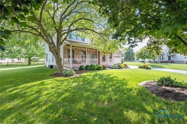 7713 Rome Ct, Holland, OH 43528 - view of front of house featuring covered porch, a front lawn, and brick siding
