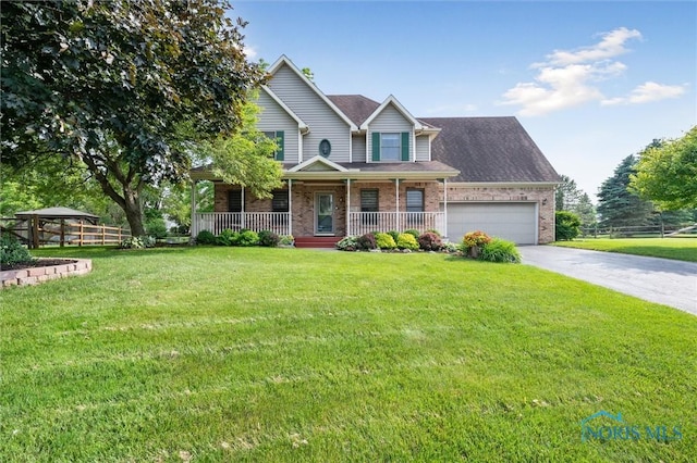 7713 Rome Ct, Holland, OH 43528 - view of front of house with brick siding, covered porch, an attached garage, driveway, and a front lawn
