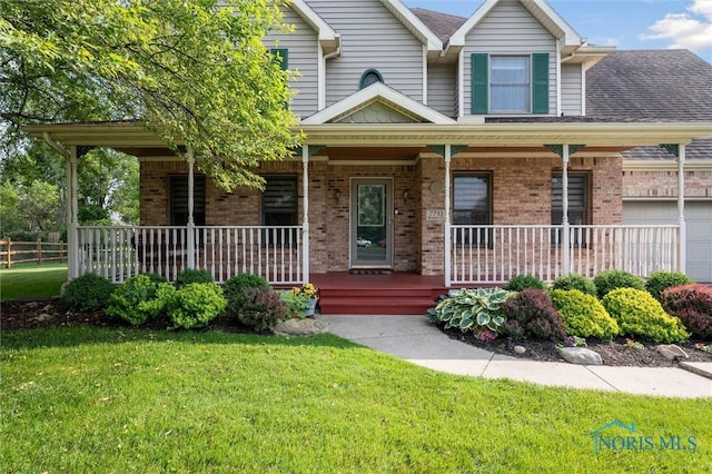 7713 Rome Ct, Holland, OH 43528 - view of front of property with covered porch, brick siding, a front lawn, and a shingled roof