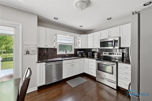 7713 Rome Ct, Holland, OH 43528 - kitchen with appliances with stainless steel finishes, plenty of natural light, white cabinetry, dark wood-style flooring, and recessed lighting