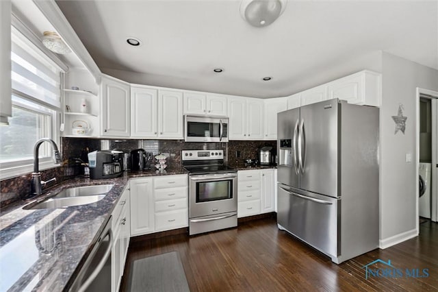 7713 Rome Ct, Holland, OH 43528 - kitchen with appliances with stainless steel finishes, dark stone counters, dark wood-type flooring, white cabinetry, and open shelves