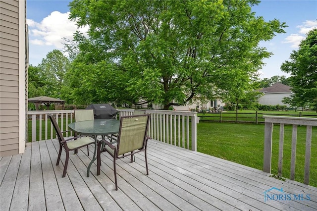 7713 Rome Ct, Holland, OH 43528 - wooden deck with outdoor dining space and a lawn