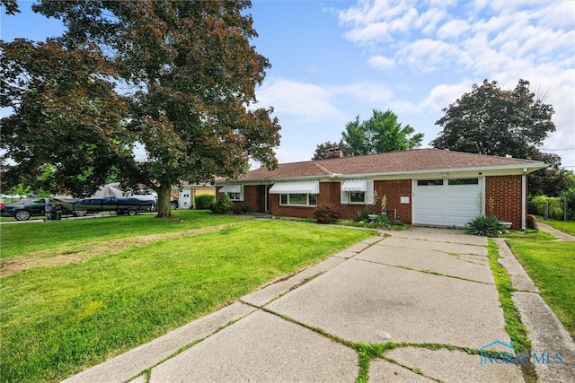 3171 Astor Ave, Toledo, OH 43614 - ranch-style home with an attached garage, brick siding, a front yard, and driveway